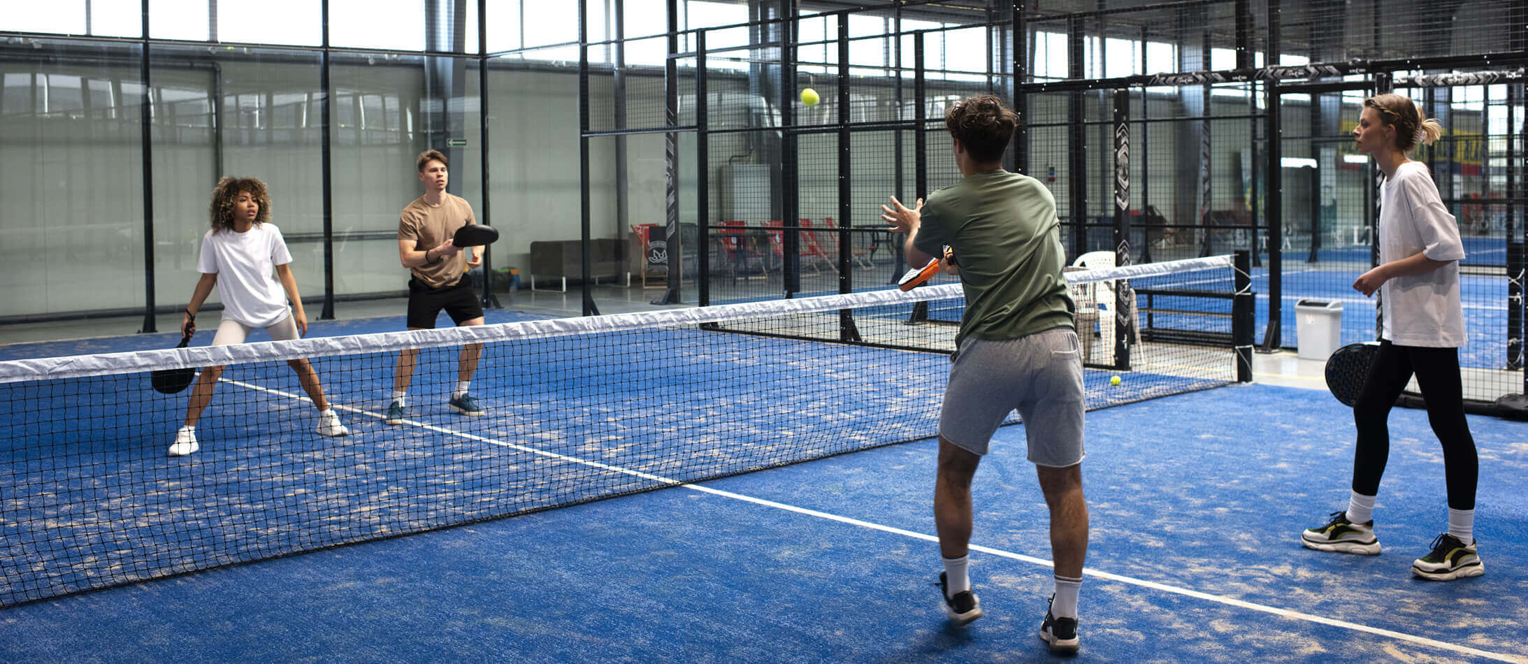 people-playing-padle-tennis-inside (1)
